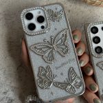 قاب موبایل ( آیفون - سامسونگ ) پروانه آموره نگین دار برجسته شاینی + بندست